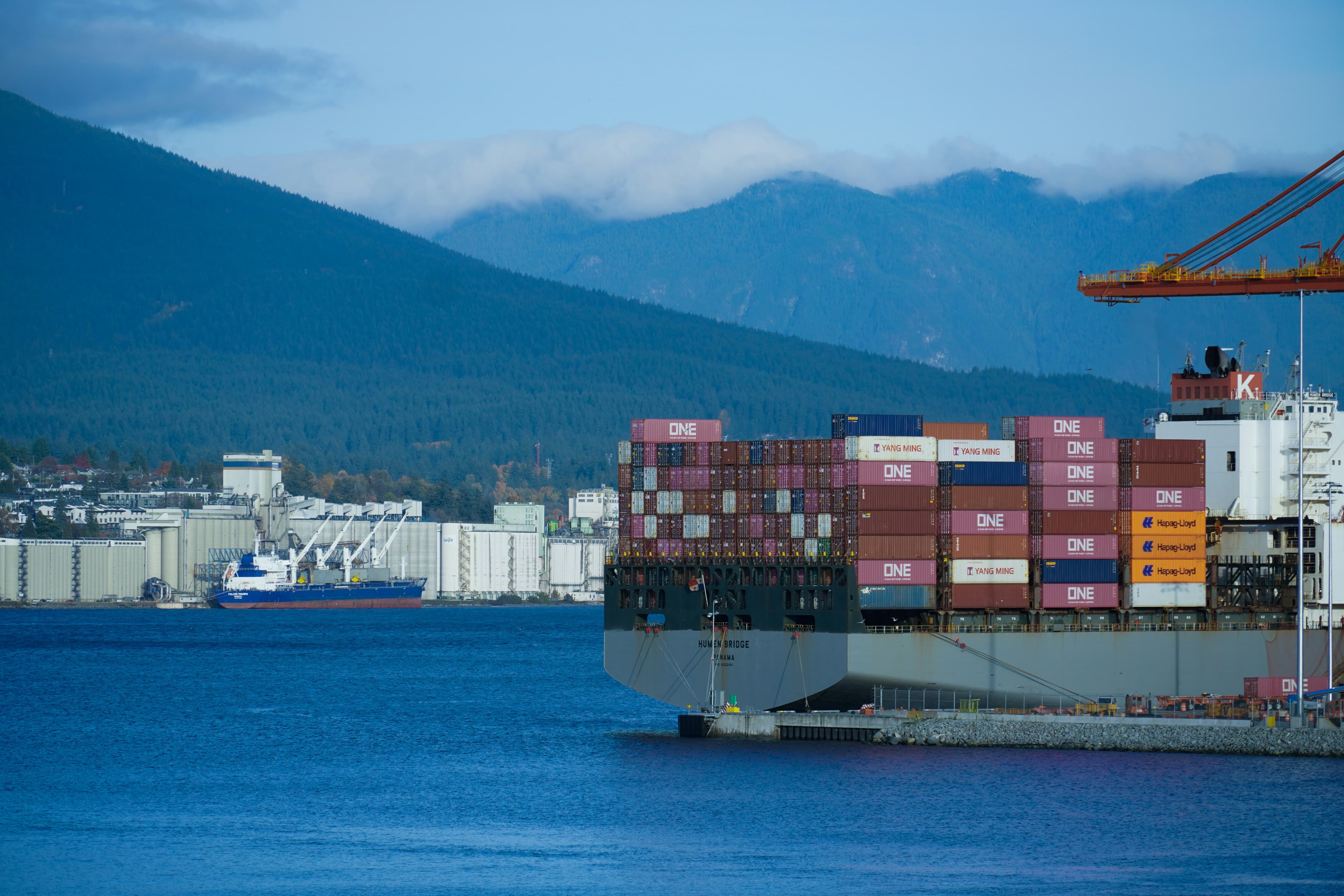 A large cargo ship in the middle of a body of water in Vancouver, Canada