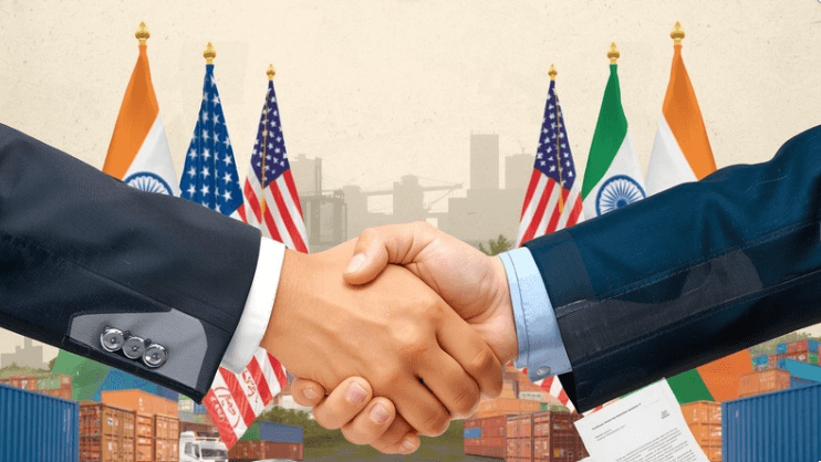 A handshake in front of the Indian and American flags symbolizes the new trade agreement between the two countries